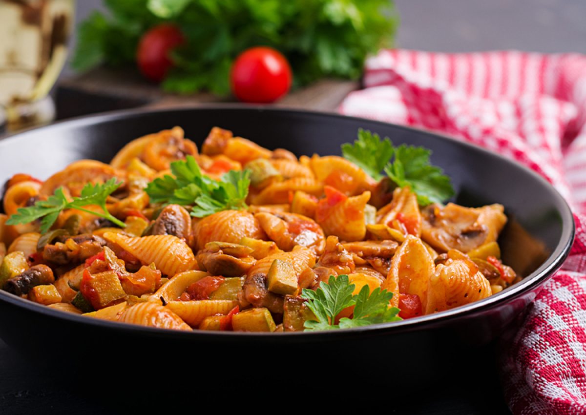 Conchiglie pasta. Italian pasta shells with mushrooms, zucchini and tomato sauce.